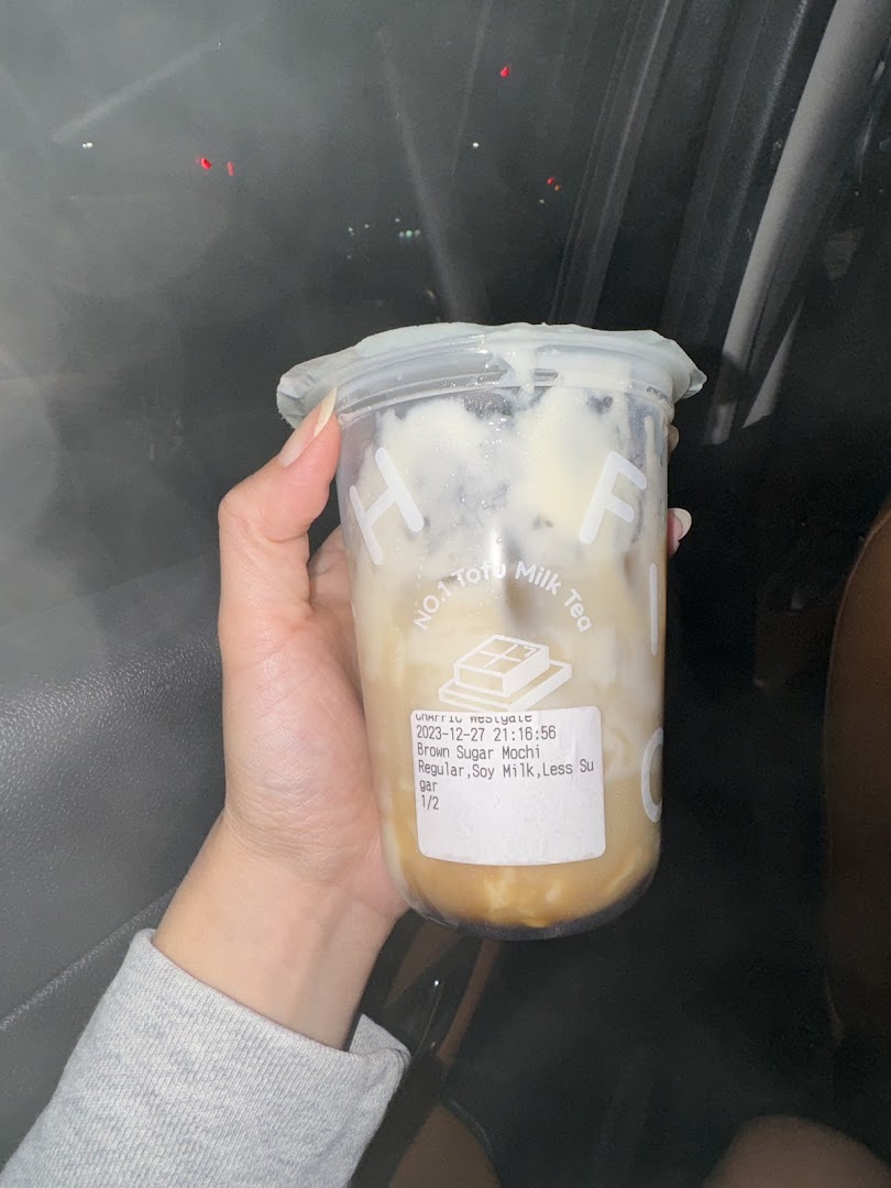 A hand holds a Chaffic Westgate brown sugar mochi drink with soy milk.