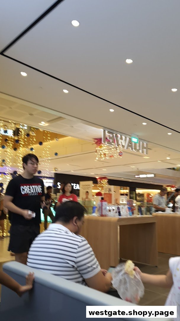 An interior shot of a shopping mall with shoppers and a Huawei electronics store in the background.