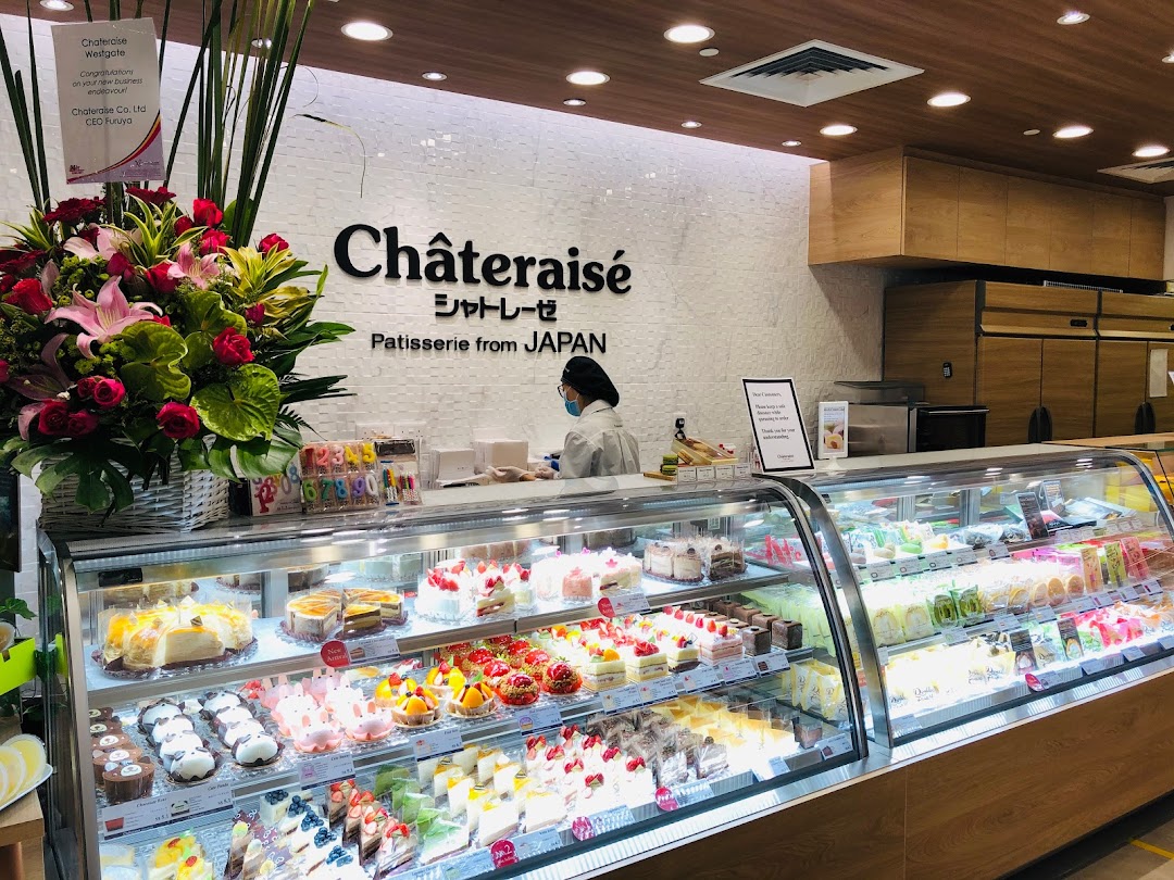 A vibrant display of Japanese pastries and cakes inside Châteraisé, showcasing a wide variety of sweet treats.
