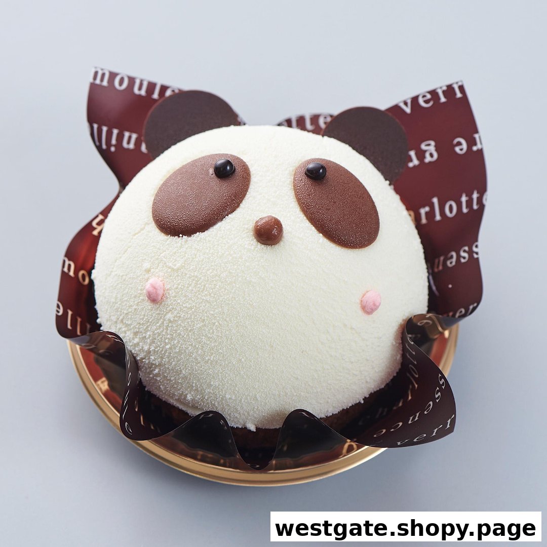 A delightful panda-shaped cake with white frosting and chocolate details, presented on a golden tray.