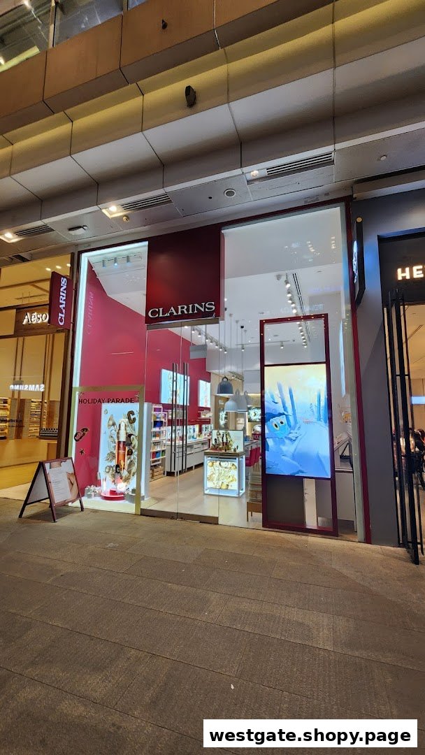 The vibrant red exterior of the Clarins boutique, showcasing its entrance and product displays.