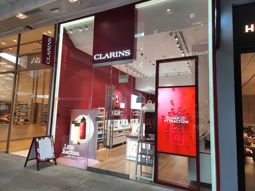 The inviting entrance of the Clarins boutique showcasing skincare products and promotions.