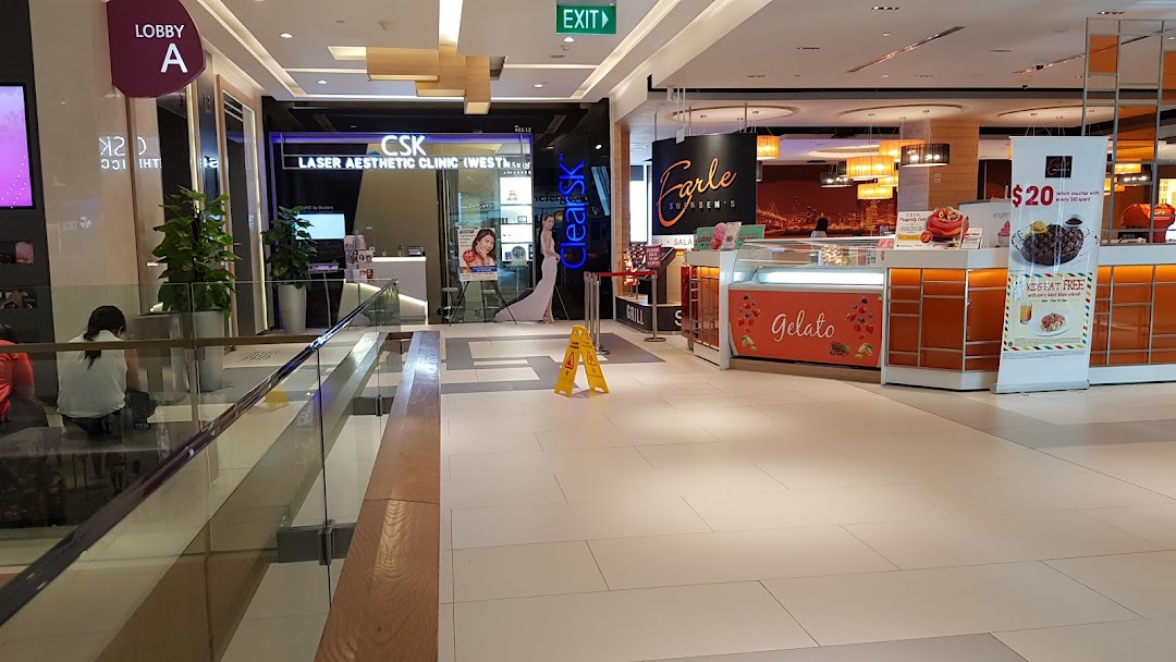 View of ClearSK Aesthetic Clinic's entrance and a nearby gelato counter within a shopping mall.