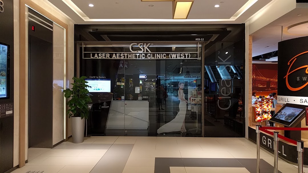 The sleek glass entrance of ClearSK Laser Aesthetic Clinic at Westgate, featuring prominent signage.