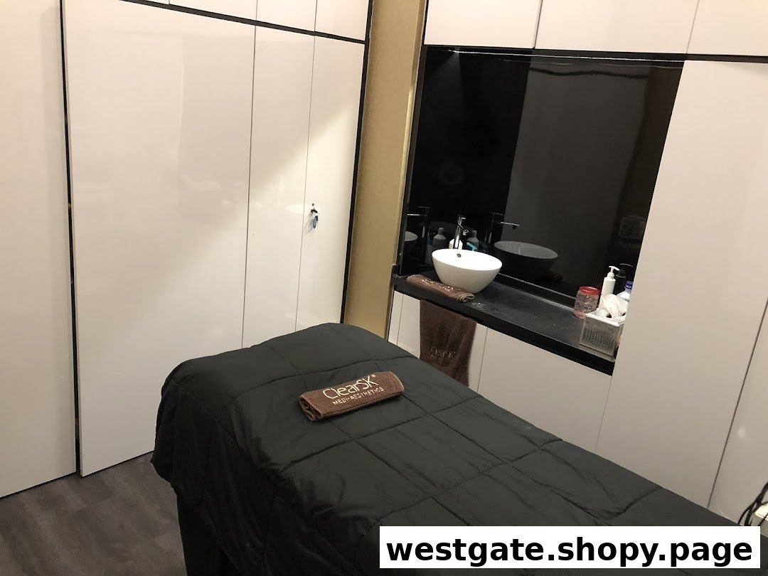 An aesthetic clinic treatment room featuring a comfortable bed and a modern sink area.