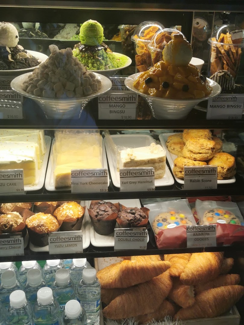 A vibrant display case showcasing Coffeesmith's selection of desserts, pastries, and refreshing bingsoo.