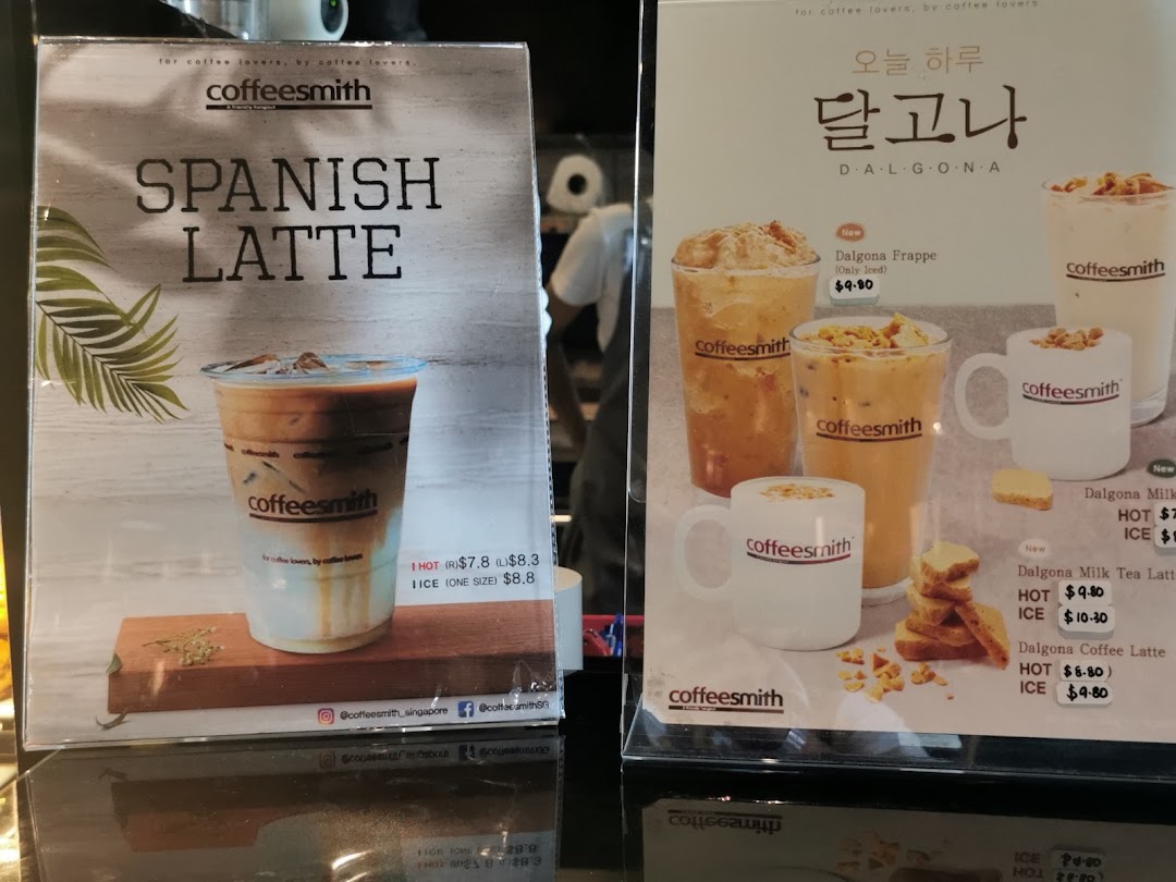 Two display stands showcasing Coffeesmith's Spanish Latte and Dalgona series drinks with prices.