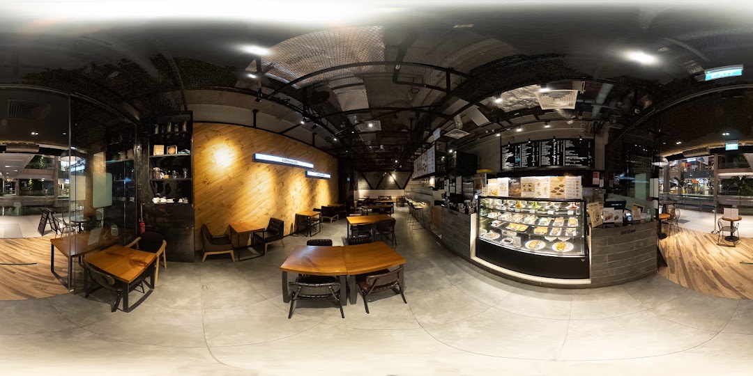 A panoramic view of Coffeesmith's modern and spacious interior, featuring seating areas, counter, and display cases.