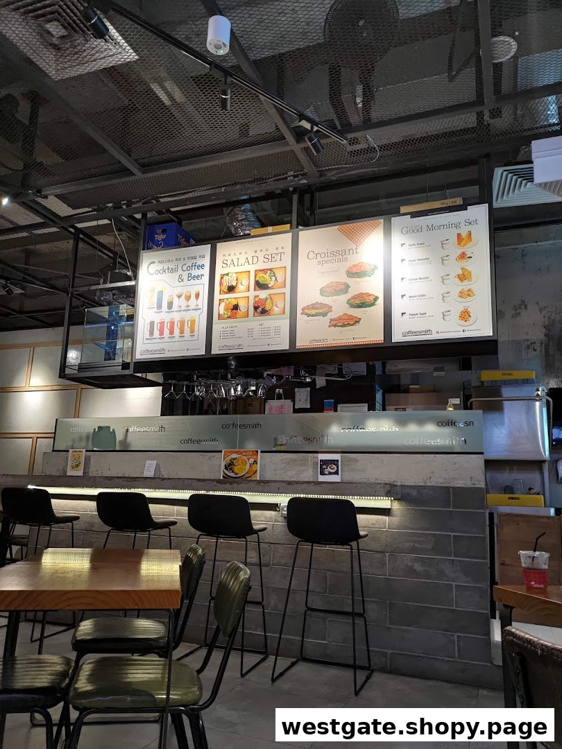 Interior view of Coffeesmith featuring menu boards for coffee, salads, croissants, and breakfast sets.