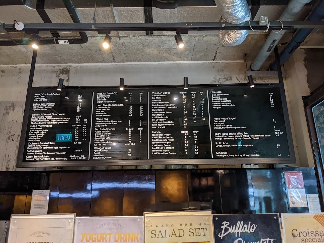 A comprehensive menu board displaying a wide range of coffee, tea, brunch, and dessert options at Coffeesmith.