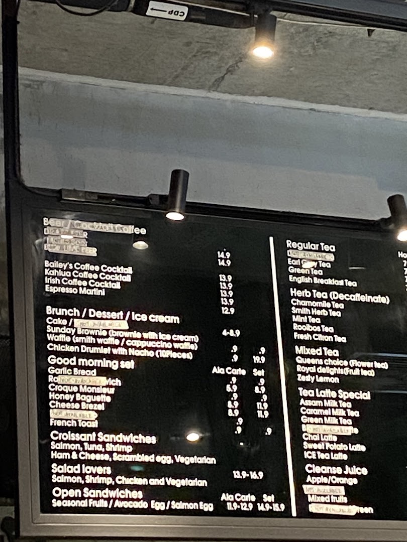A digital menu board displaying a variety of coffee, tea, brunch, and sandwich options with prices.