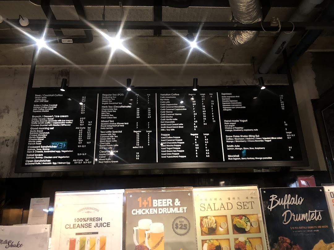 A detailed digital menu board for Coffeesmith, displaying various coffee, tea, dessert, and food options with prices.