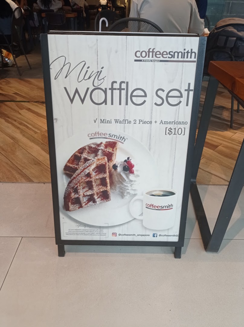 An A-frame sign outside Coffeesmith advertising a Mini Waffle Set with Americano for $10.