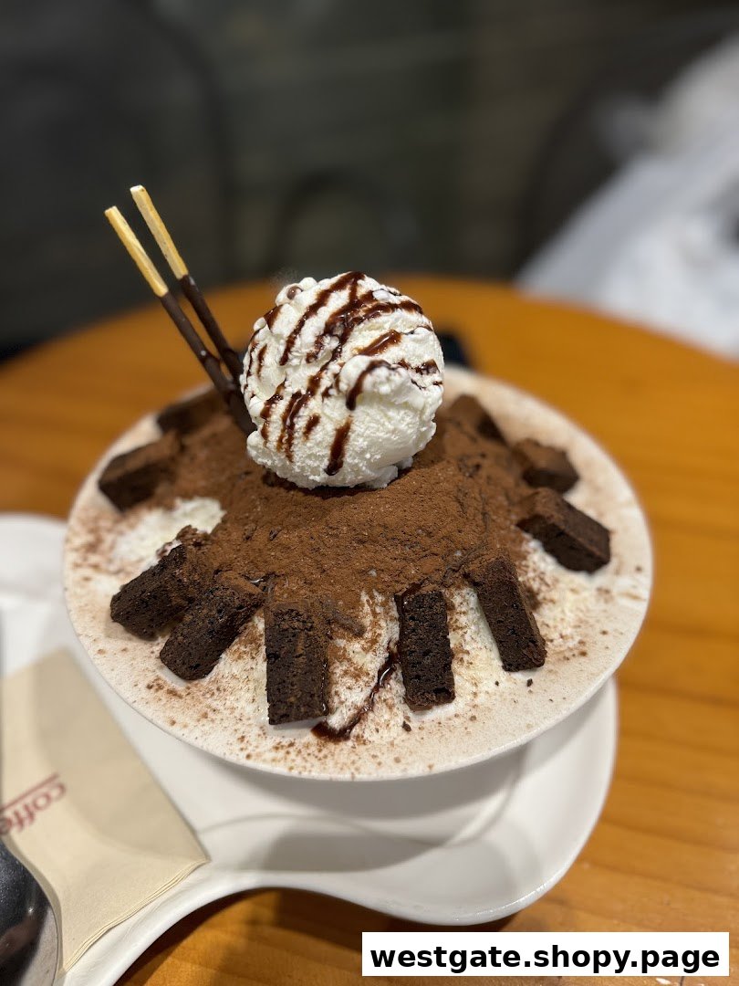 A delicious chocolate bingsu topped with vanilla ice cream, chocolate drizzle, and brownie pieces.
