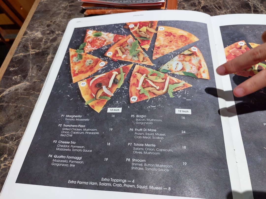 A detailed view of COLLINS' pizza menu, showcasing various pizza options and prices.