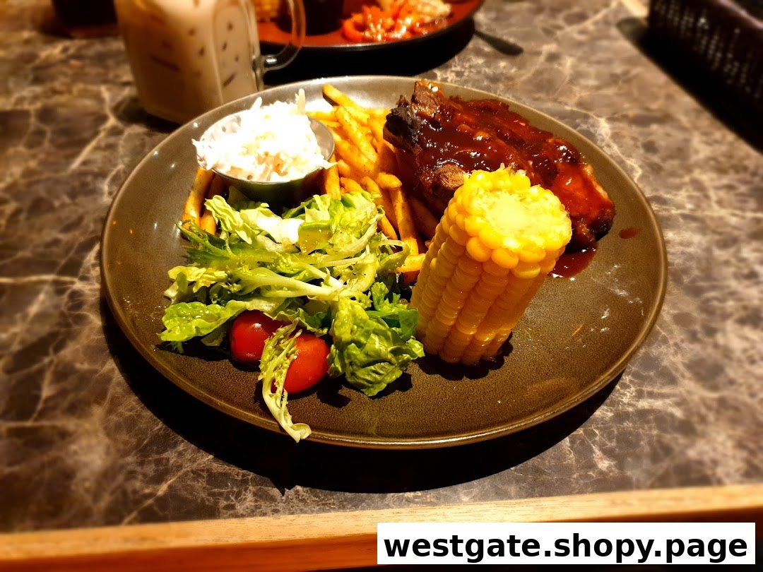 A plate of BBQ ribs, fries, salad, coleslaw, and corn on the cob.