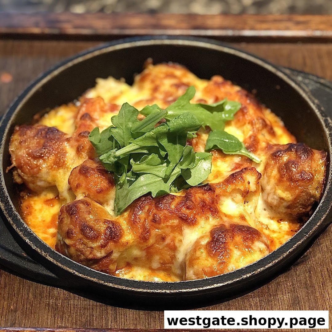 A close-up of a cheesy baked dish, possibly gnocchi or pasta, topped with fresh arugula.