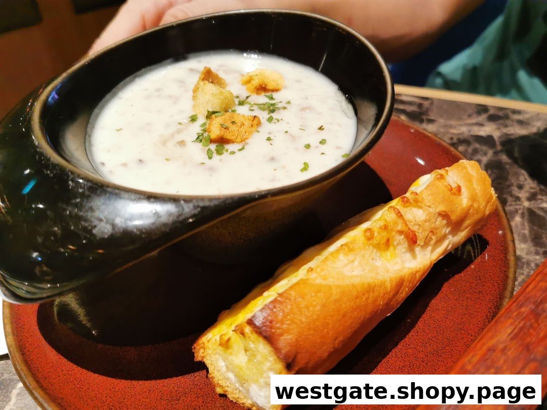 A creamy mushroom soup with croutons and a side of cheesy breadstick on a red plate.