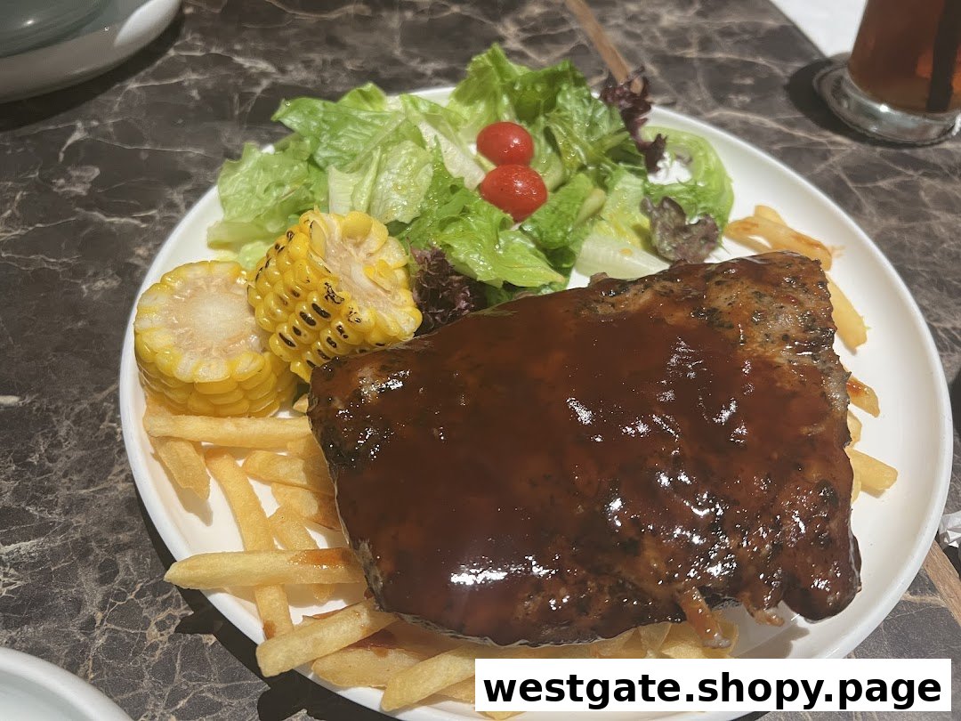 A plate of BBQ ribs with fries, corn on the cob, and a fresh side salad.