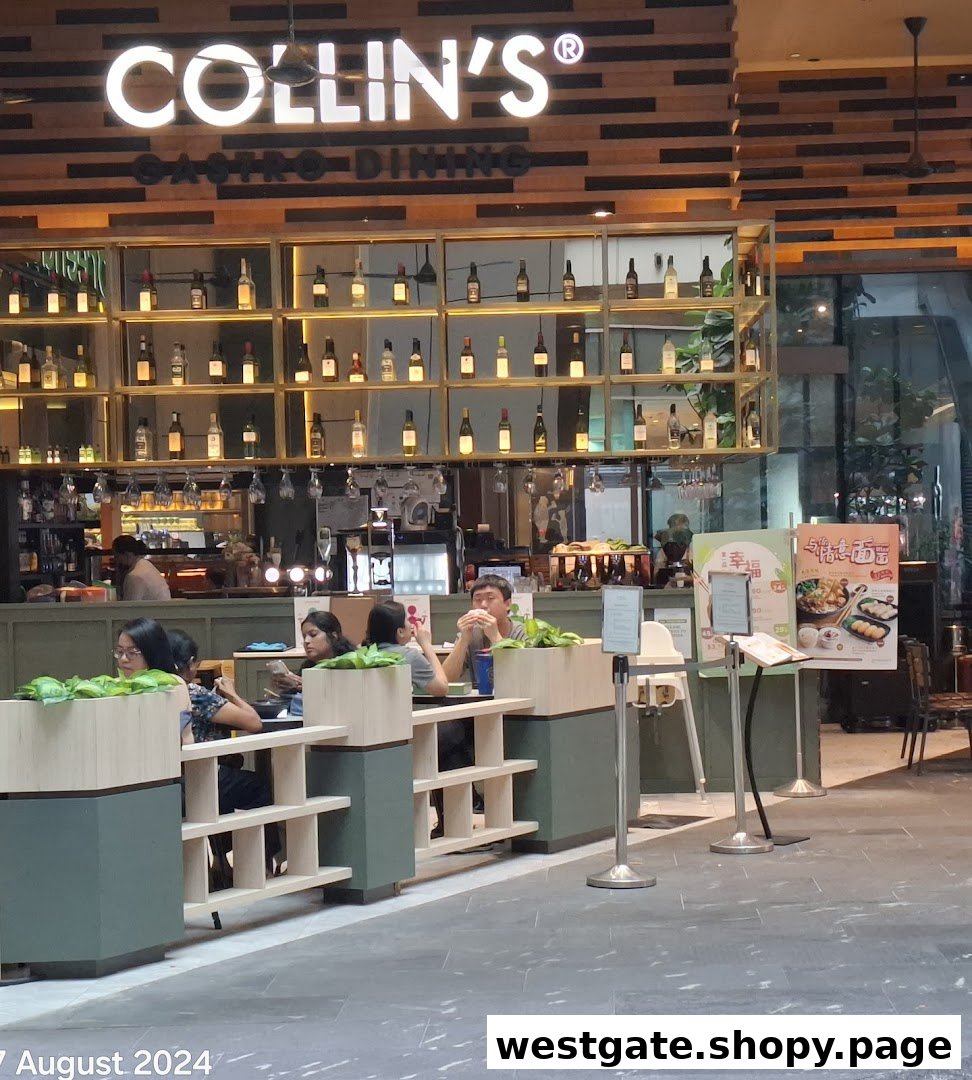 Interior view of COLLIN'S Gastro Dining, featuring customers, a bar, and a stylish bottle display.