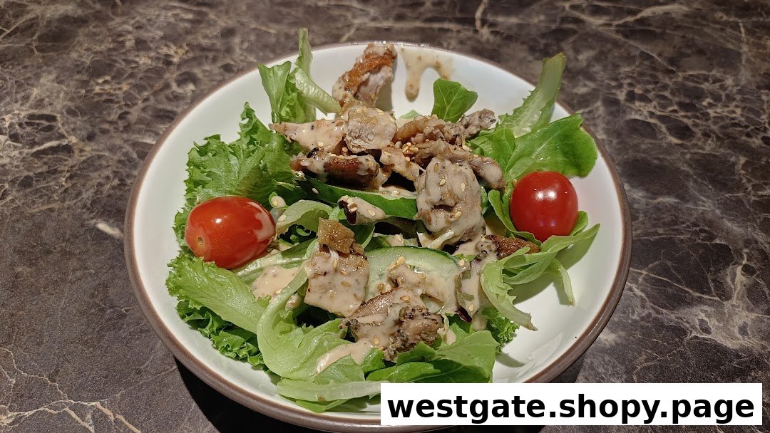 A vibrant salad featuring grilled chicken, fresh greens, cherry tomatoes, and a creamy dressing.