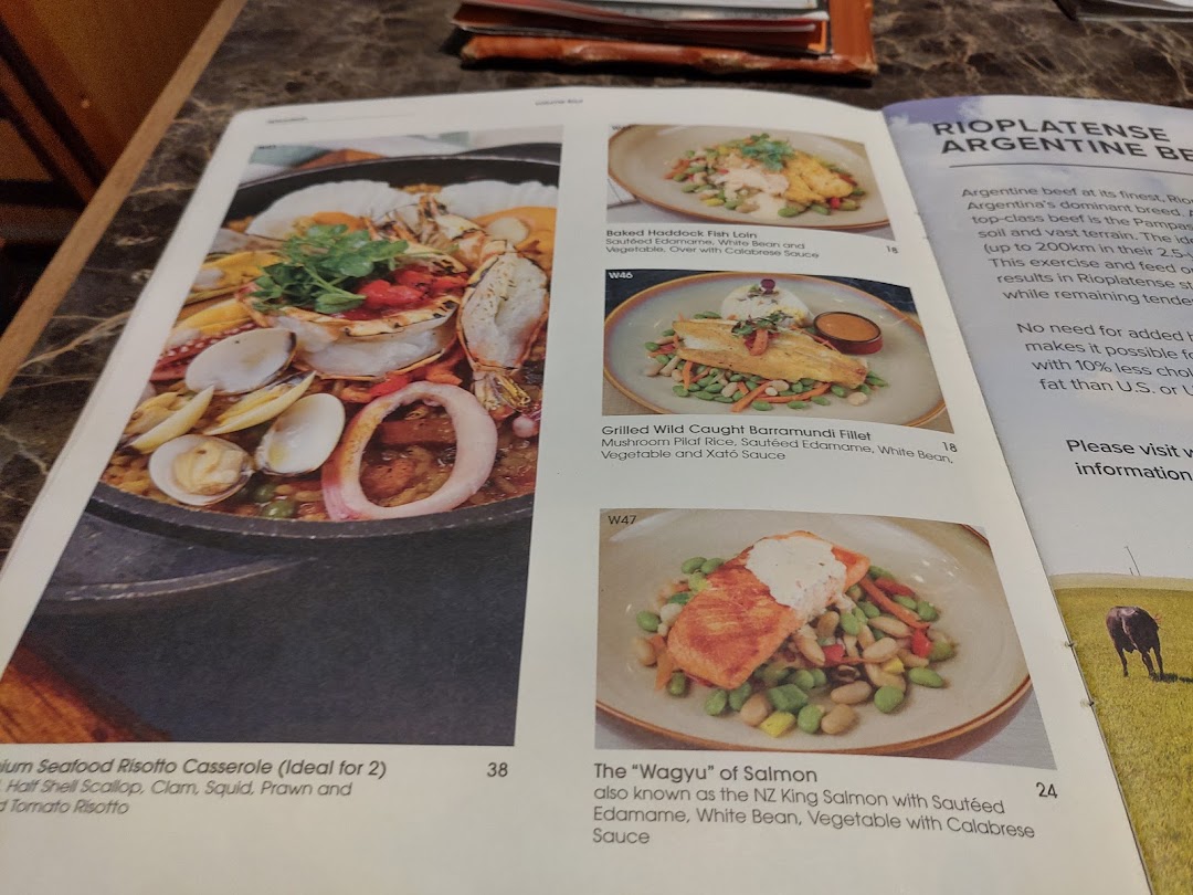 A restaurant menu displaying various seafood and fish dishes with descriptions and prices.