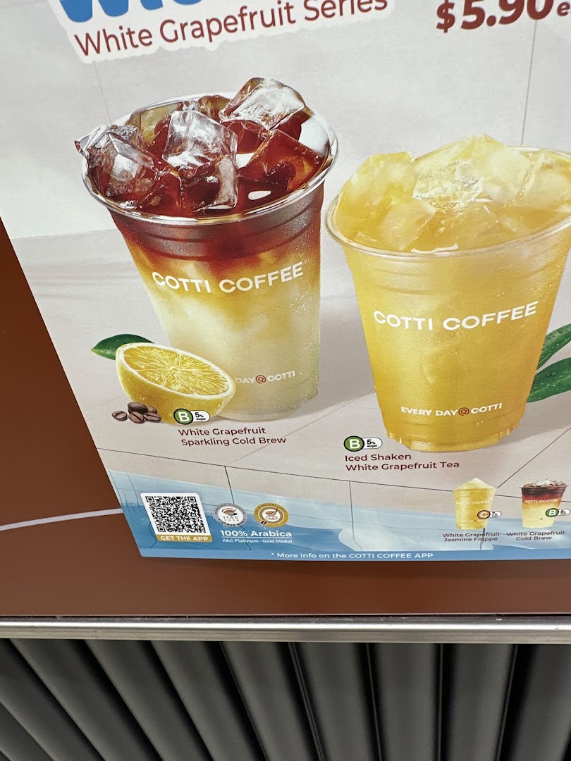 A menu board showcasing Cotti Coffee's White Grapefruit Series drinks, including cold brew and iced tea.