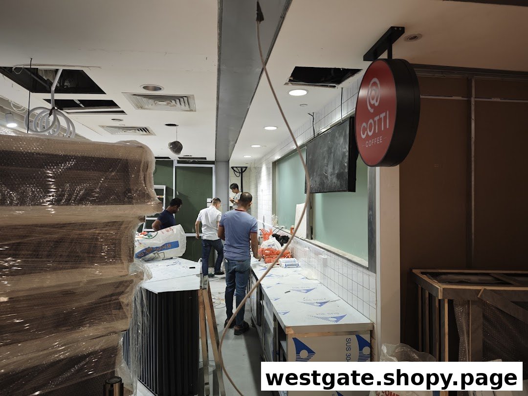 Workers are setting up the interior of a Cotti Coffee shop, with equipment and materials visible.