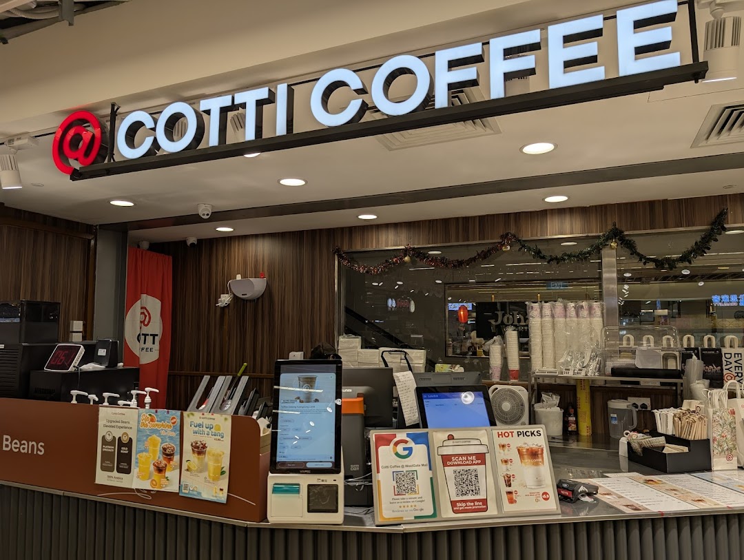 The vibrant counter and service area of Cotti Coffee, showcasing branding and promotional displays.