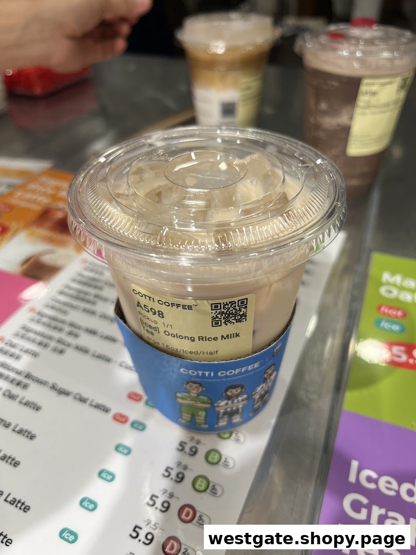 A refreshing Iced Oolong Rice Milk Tea from Cotti Coffee, with a partial menu visible in the background.