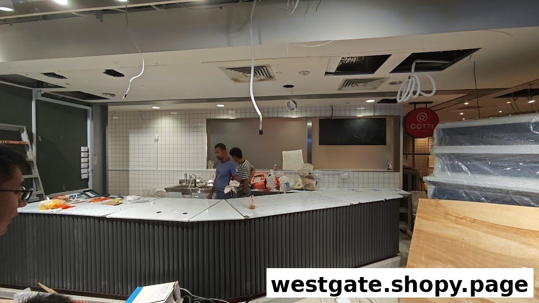 Interior view of Cotti Coffee under construction, featuring the counter area and workers.