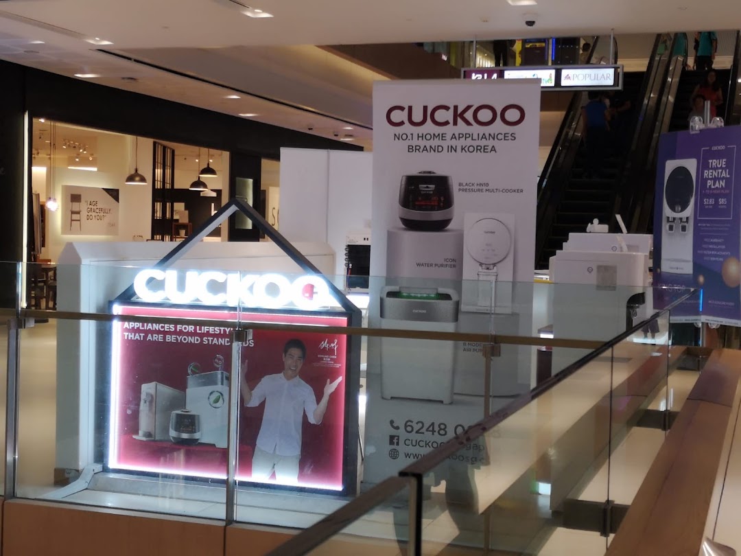 A CUCKOO brand display showcasing Korean home appliances like water purifiers and multi-cookers in a mall.