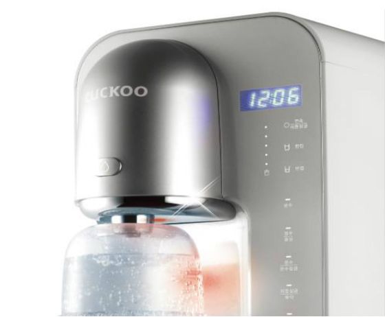 Close-up of a modern CUCKOO water dispenser with digital display and control panel.