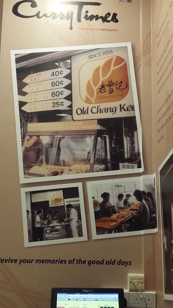 A wall display at Curry Times featuring vintage photos, Old Chang Kee branding, and a price list for traditional snacks.
