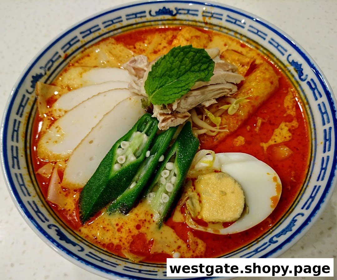 A vibrant bowl of curry noodles with fish cake, okra, chicken, and egg.