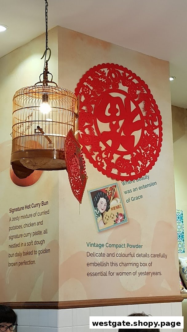 Interior wall decor at Curry Times featuring a birdcage light, red paper cutouts, and descriptive text.