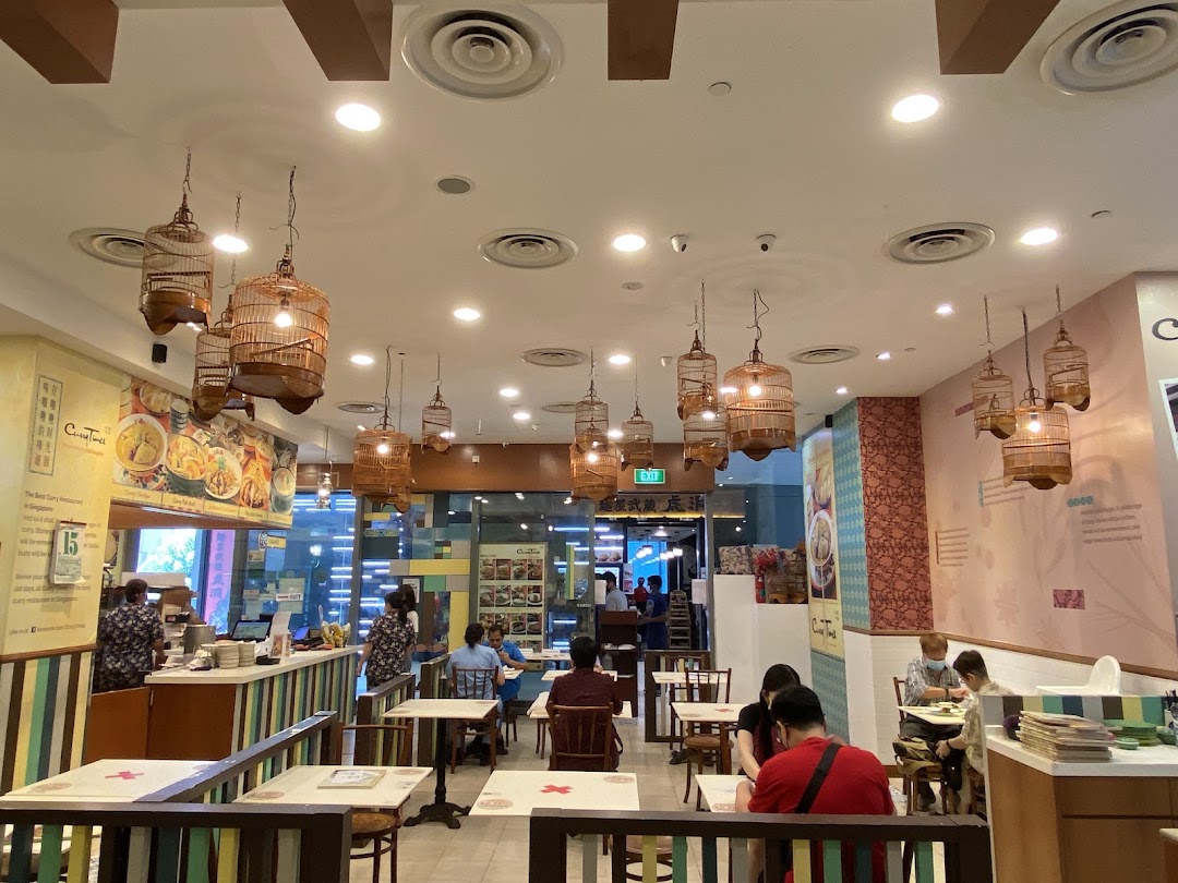 Interior view of Curry Times restaurant, featuring unique birdcage lighting and diners enjoying their meal.
