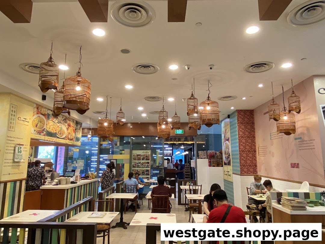Interior view of Curry Times restaurant, featuring unique birdcage lighting and diners enjoying their meal.