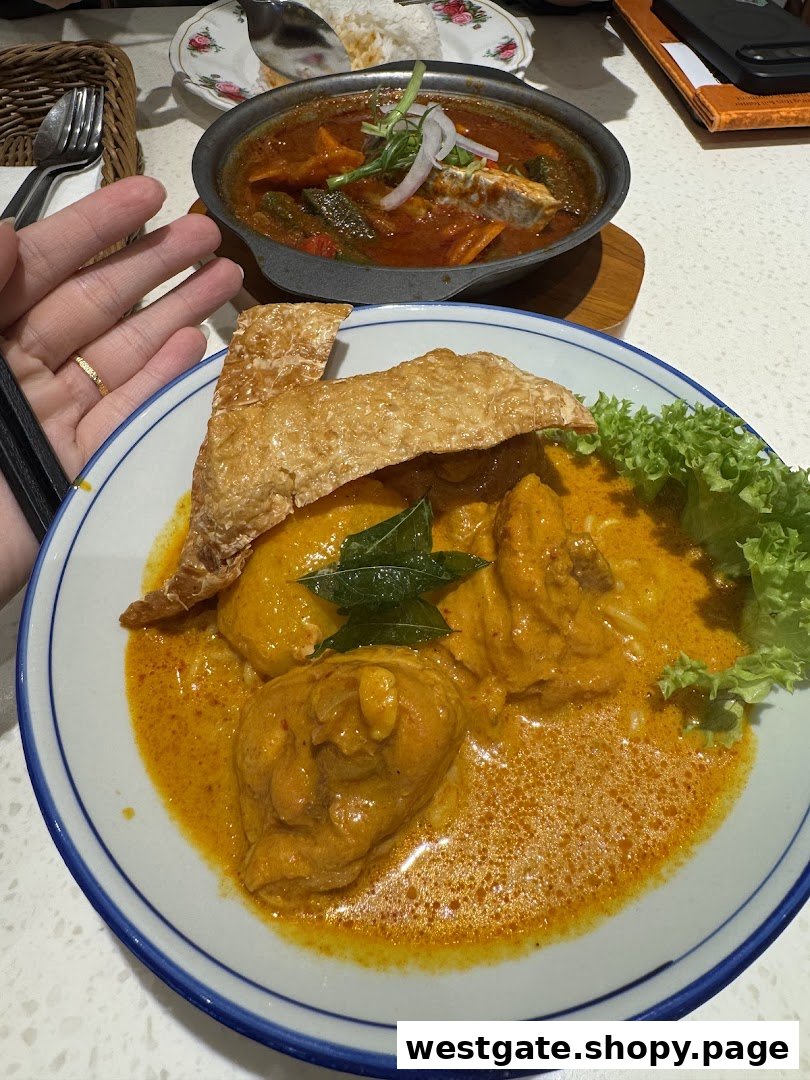Two delicious curry dishes, including chicken curry with crispy topping, served on a table.