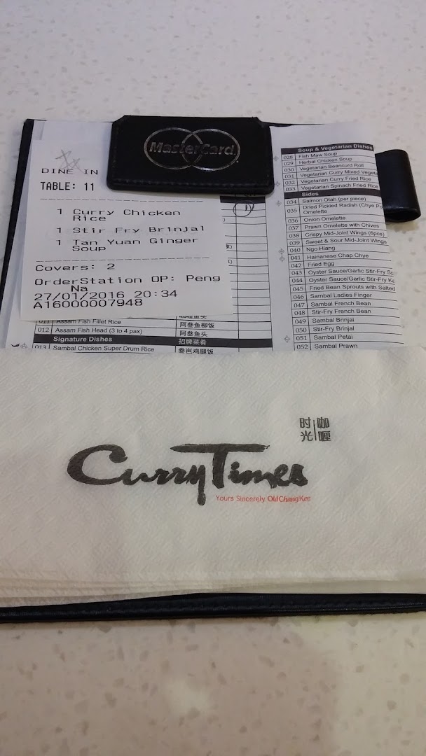 An order slip and branded napkin from Curry Times are displayed on a table.