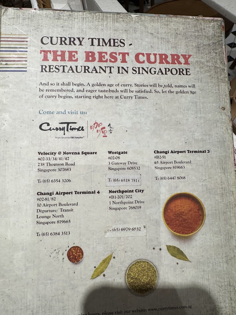 Information board for Curry Times, promoting it as 'The Best Curry Restaurant in Singapore' with branch details.