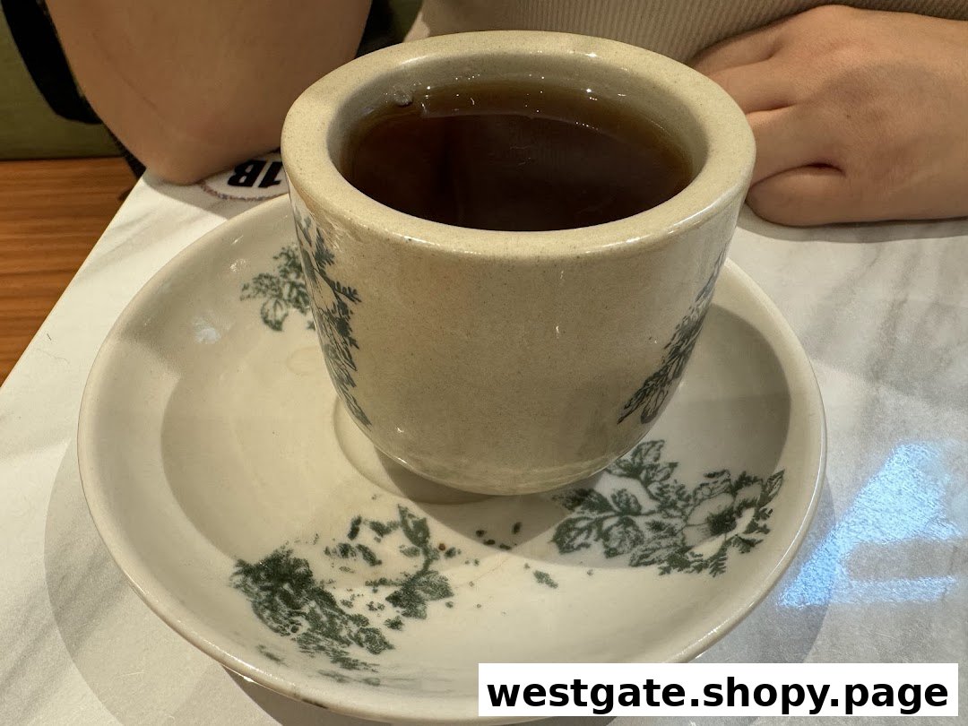 A traditional cup of hot beverage on a patterned saucer at Curry Times.