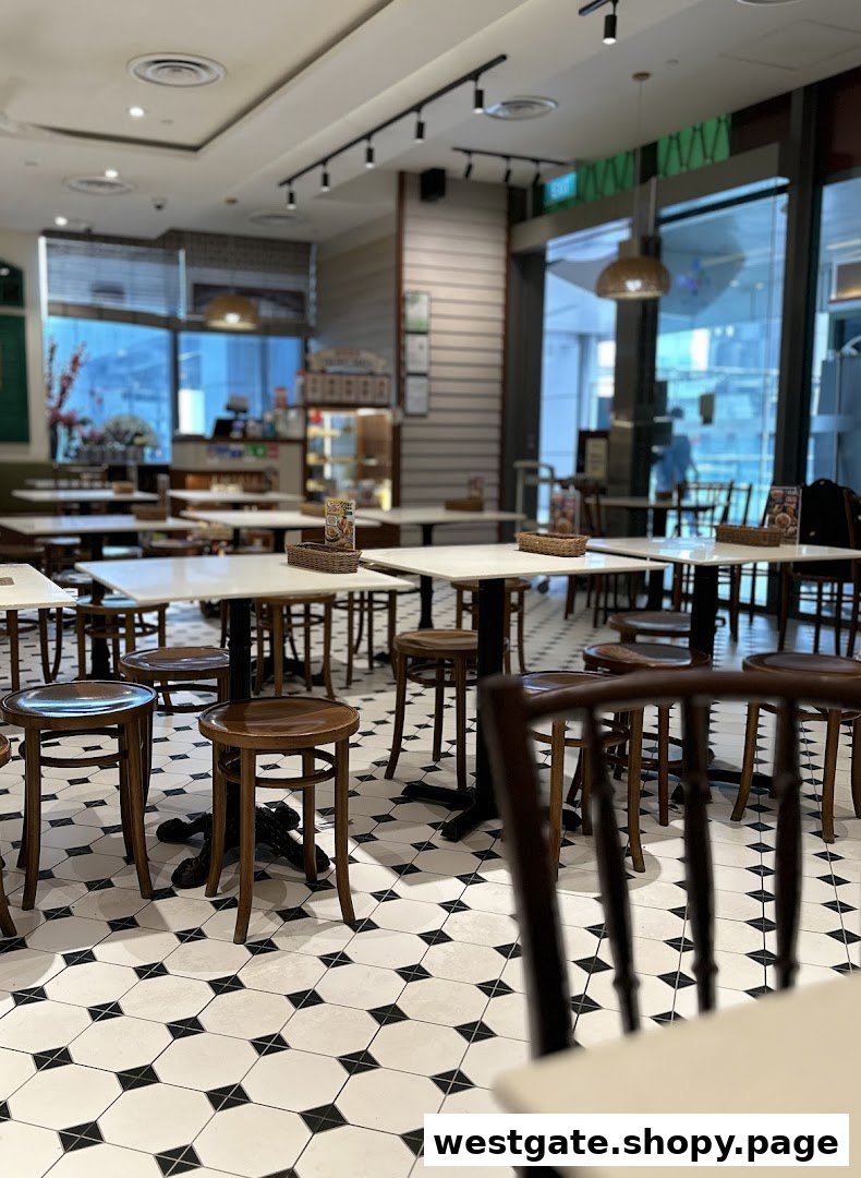 Interior view of Curry Times restaurant with empty tables, stools, and distinctive black and white tiled flooring.