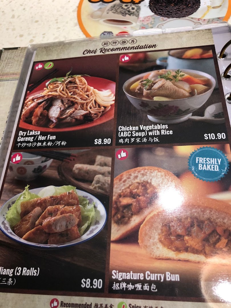 A menu page from Curry Times showcasing popular dishes like Dry Laksa, Chicken Soup, and Signature Curry Bun.