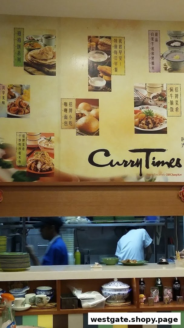 A promotional wall display at Curry Times featuring various food items and the restaurant's logo.