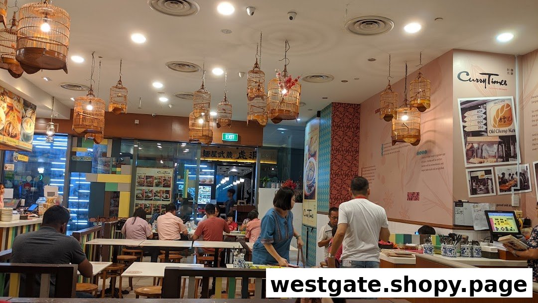 Interior view of Curry Times restaurant with customers dining and distinctive birdcage-style lighting.
