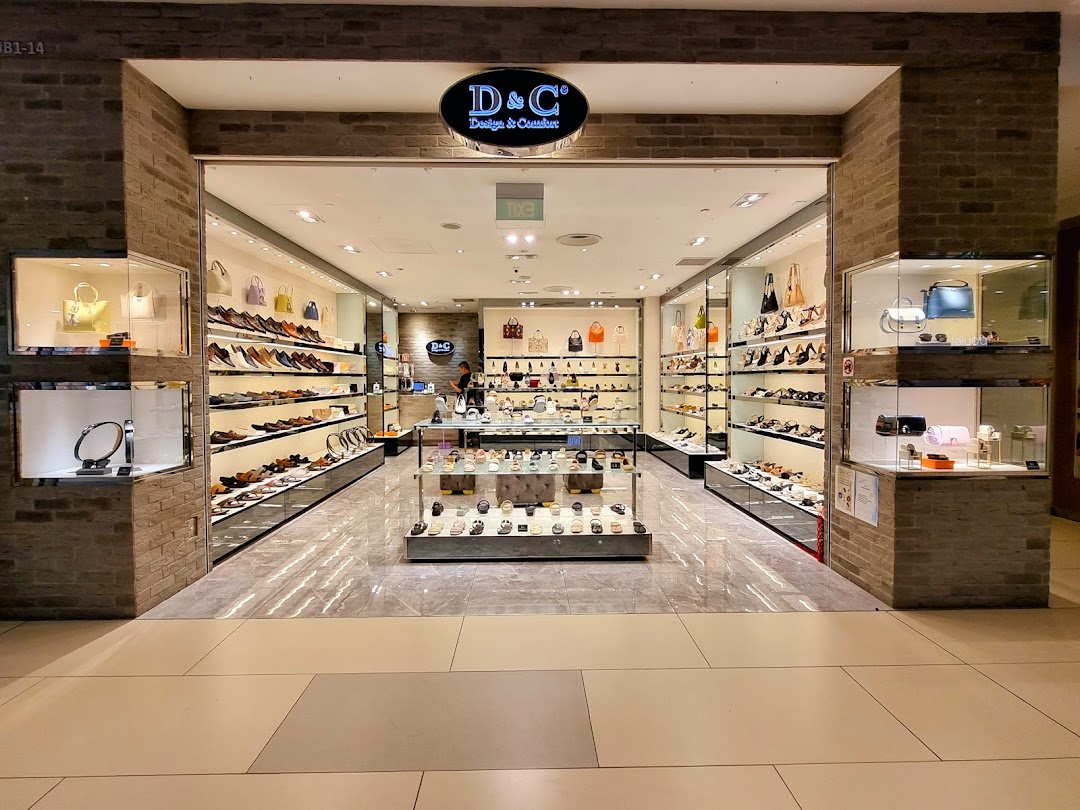 A well-lit retail shop entrance showcasing a wide array of shoes, bags, and accessories.