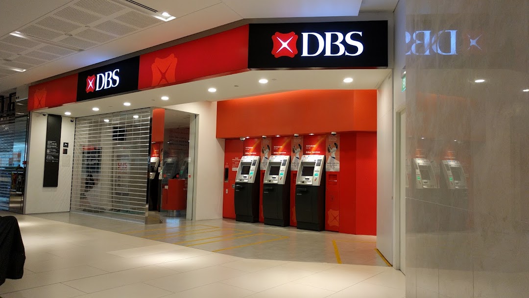 The exterior of a DBS bank branch with multiple ATMs and a closed entrance shutter.