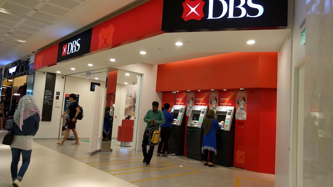 The entrance and ATM area of a DBS Bank branch with customers using services.