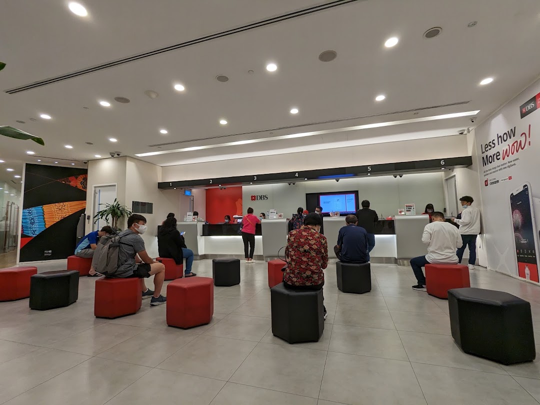 Customers waiting and being served at the counters inside a DBS bank branch.